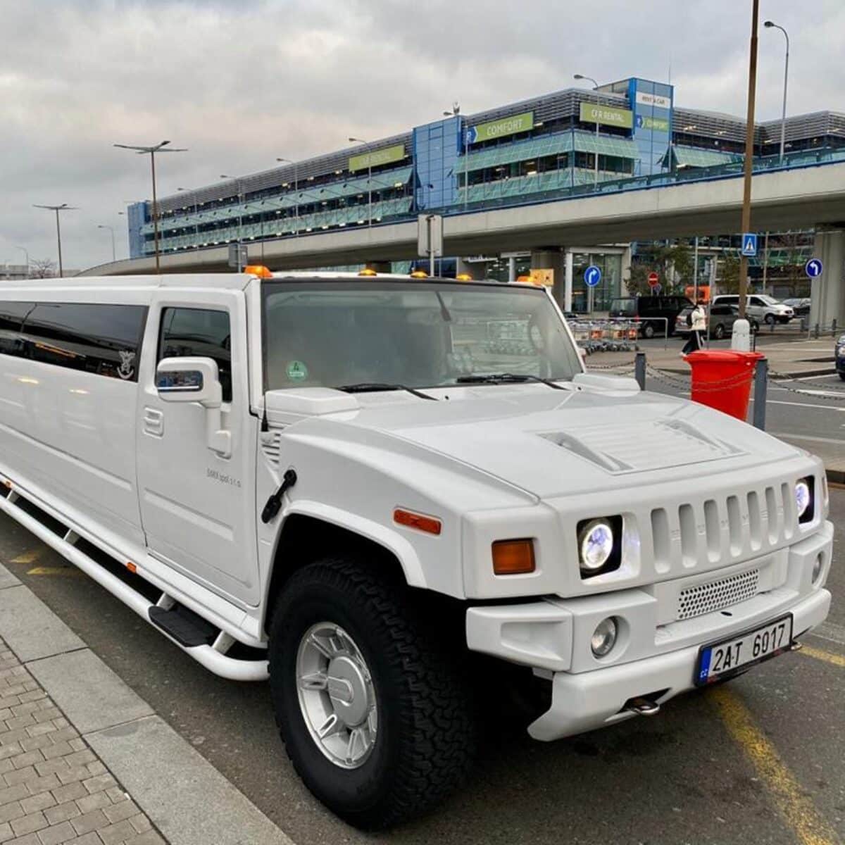 A hummer limousine is waiting at the Prague airport for a stag do group to arrive