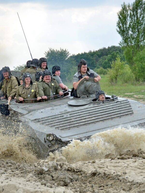 A stag do group riding in a BMP-1 during their Prague stag do weekend