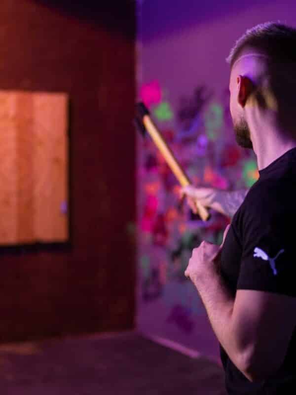 A man aiming with his axe in a room during axe throwing activity in Prague.