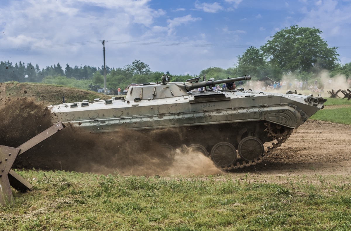A BMP-1 riding through mud